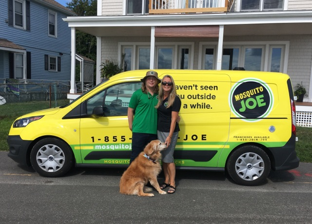 Image of Mosquito Joe owners and their dog in front of Mosquito Joe van