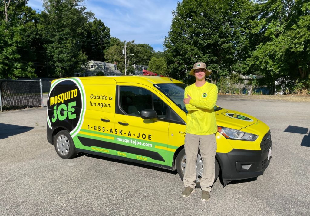 Eddie, Field Technician for Mosquito Joe of Northern Fairfield County standing in front of yellow and green van ready to make outside fun again in CT!